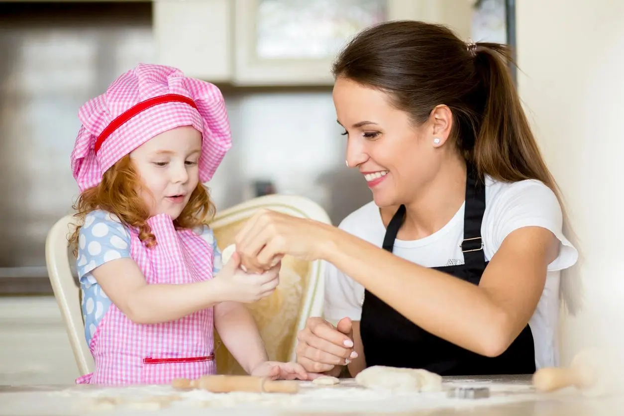 Women and baby preparing meal